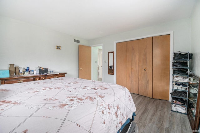 bedroom featuring light hardwood / wood-style floors and a closet