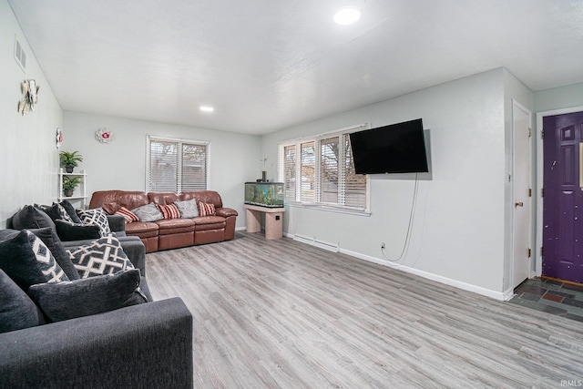 living room featuring light wood-type flooring and a baseboard radiator