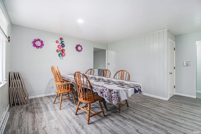 dining room with hardwood / wood-style flooring and a baseboard radiator