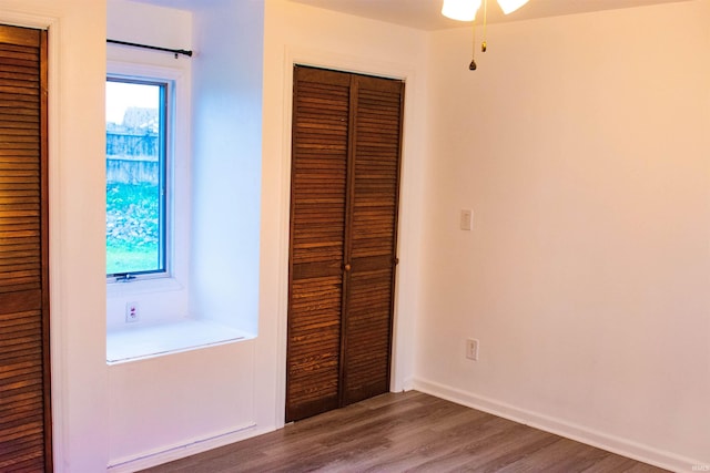 unfurnished bedroom with a closet and dark hardwood / wood-style floors