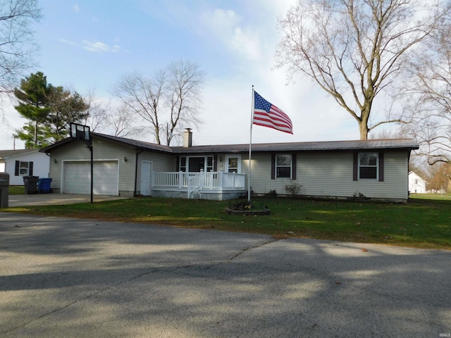 ranch-style house featuring a front yard, a porch, and a garage