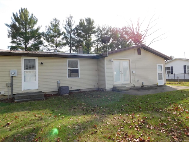 back of house featuring a patio area, a yard, and french doors