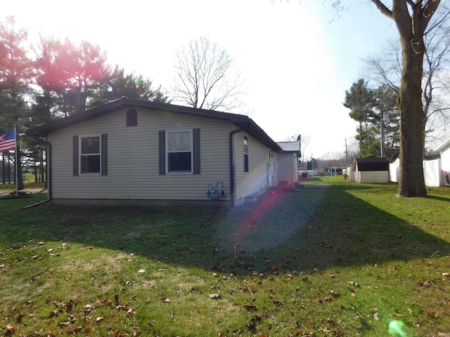 view of side of property featuring a yard and a shed