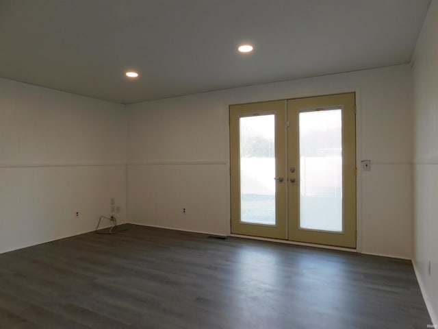 empty room with french doors and dark wood-type flooring