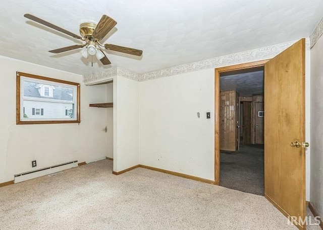 unfurnished room with ceiling fan, light colored carpet, and a baseboard heating unit