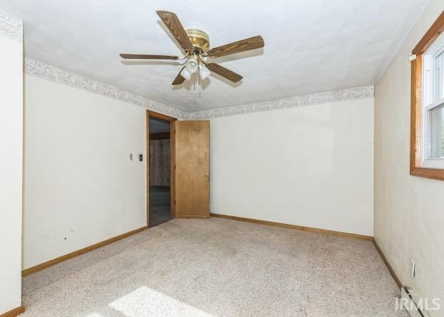 carpeted spare room with ceiling fan