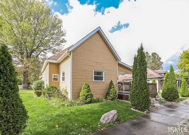 view of property exterior featuring a lawn and a deck