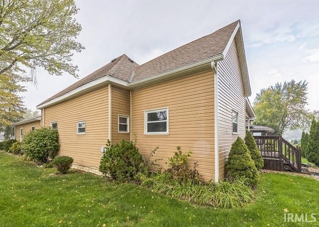 view of side of property with a lawn