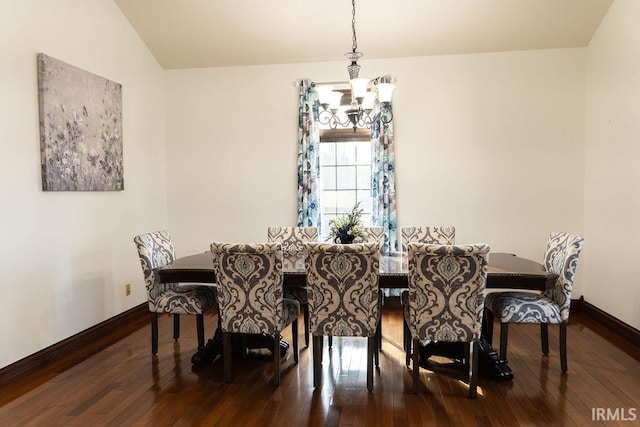 dining room with hardwood / wood-style floors, a notable chandelier, and lofted ceiling