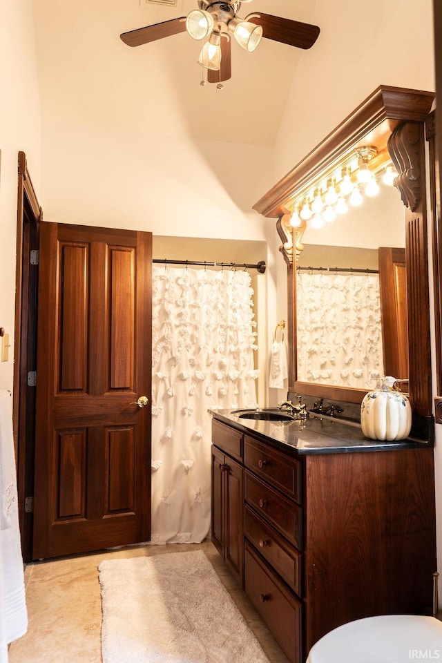 bathroom with vanity, vaulted ceiling, and ceiling fan