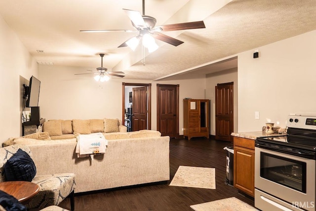 living room with ceiling fan, dark hardwood / wood-style flooring, and a textured ceiling