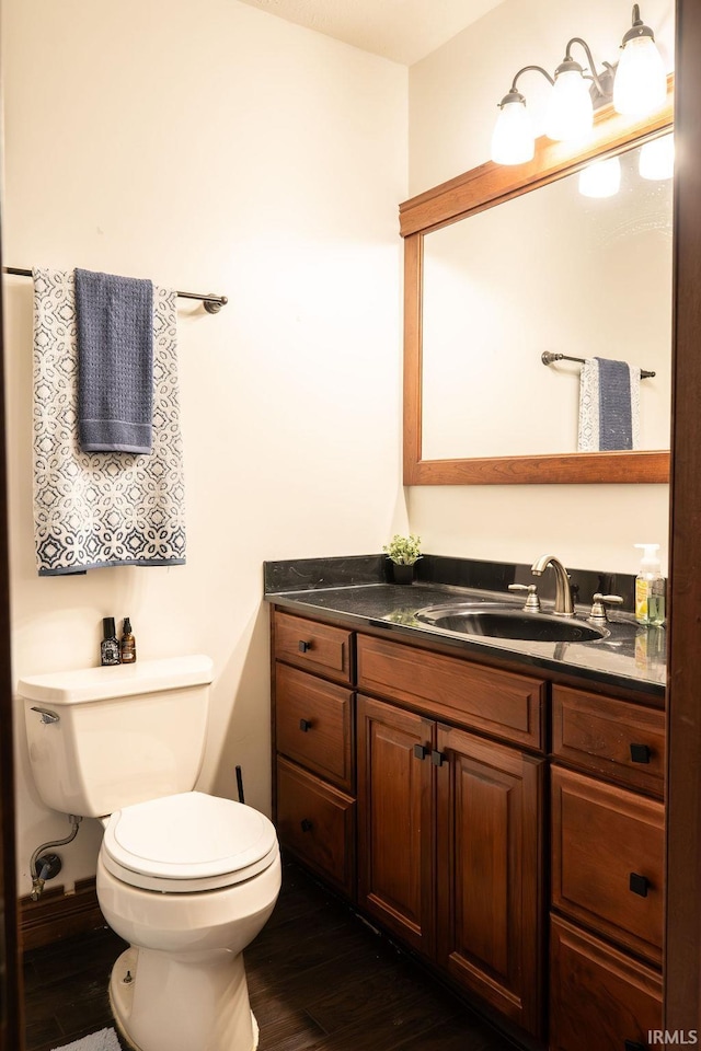 bathroom featuring hardwood / wood-style floors, vanity, and toilet