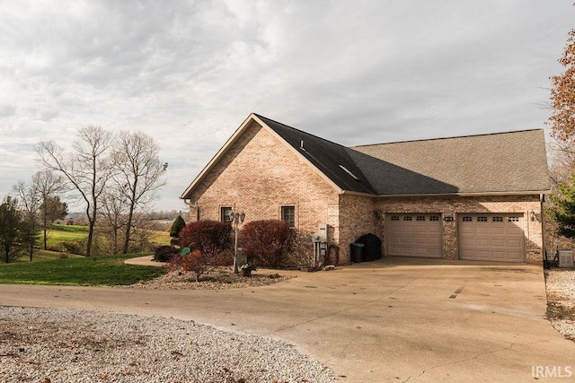 view of front of home featuring a garage and central AC unit