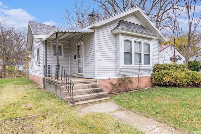 bungalow-style house featuring a front yard