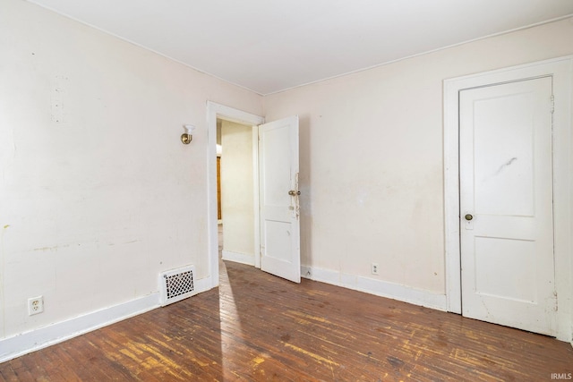 spare room featuring dark hardwood / wood-style flooring