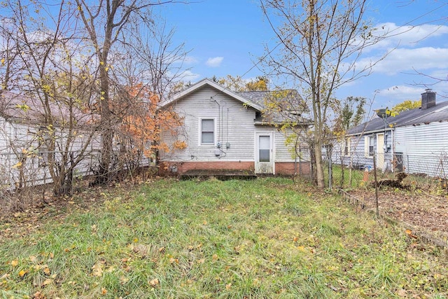 rear view of house with a yard