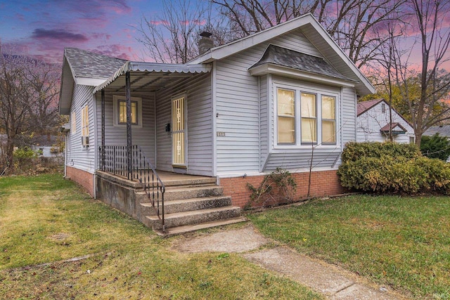 bungalow featuring a yard