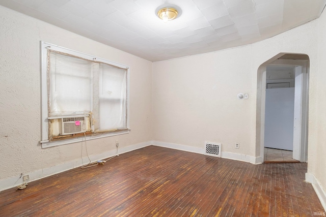 spare room with dark hardwood / wood-style flooring and cooling unit