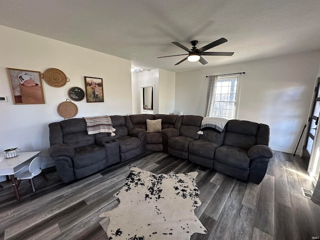 living room featuring a textured ceiling, dark hardwood / wood-style flooring, and ceiling fan