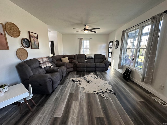 living room with ceiling fan and dark hardwood / wood-style floors