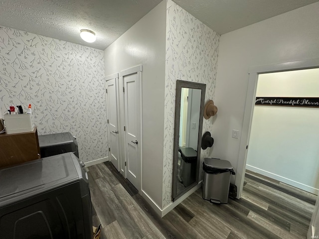 interior space with separate washer and dryer, a textured ceiling, and hardwood / wood-style flooring