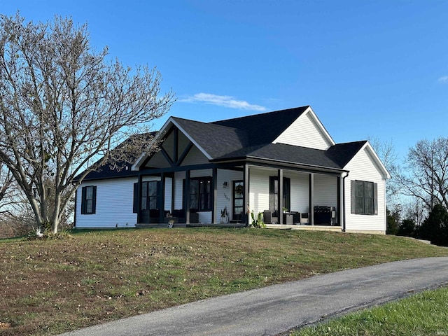 view of front of house featuring a front yard and covered porch