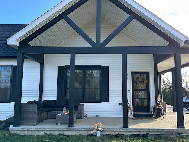 back of house featuring outdoor lounge area and covered porch