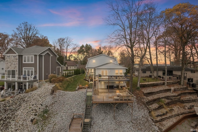 yard at dusk featuring a deck