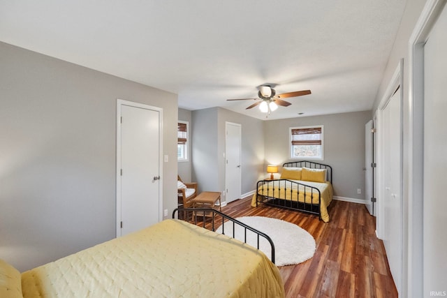 bedroom featuring ceiling fan and dark wood-type flooring