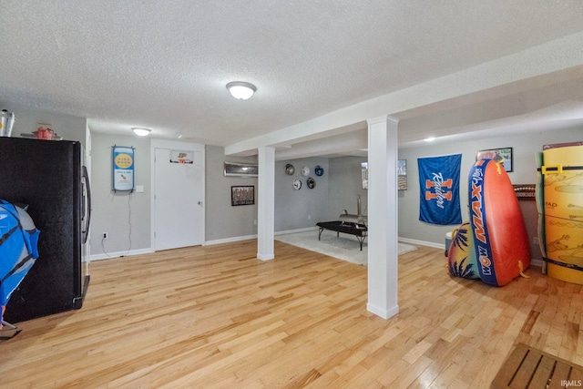 interior space with a textured ceiling and light wood-type flooring