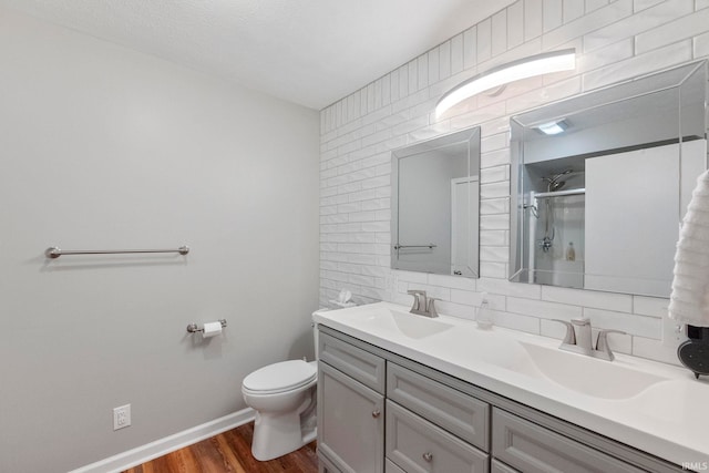 bathroom with walk in shower, tasteful backsplash, toilet, vanity, and hardwood / wood-style flooring