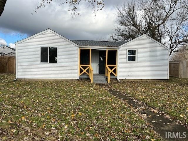 back of house with a lawn