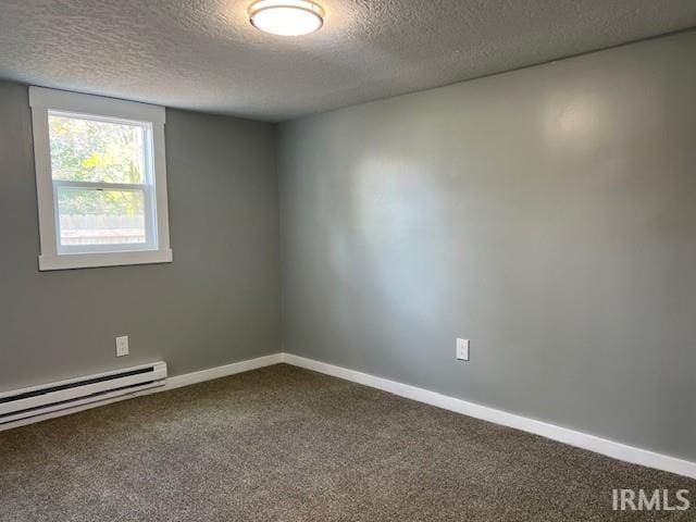 carpeted spare room featuring baseboard heating and a textured ceiling