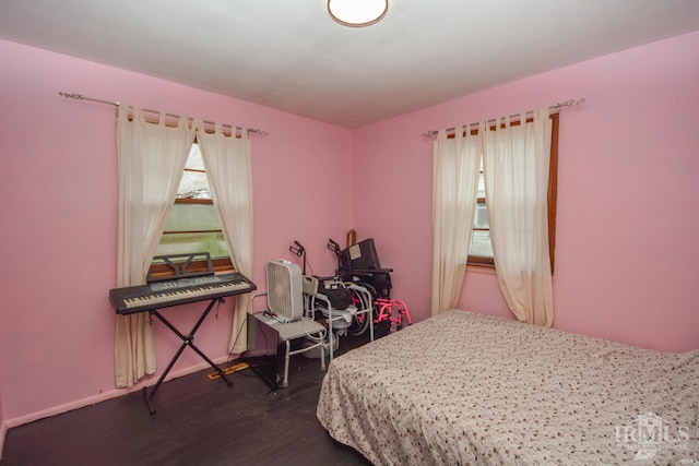 bedroom with dark hardwood / wood-style floors