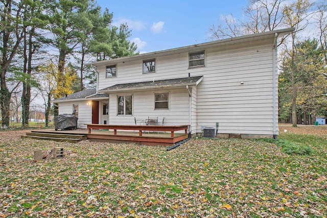 back of property with central AC unit and a wooden deck