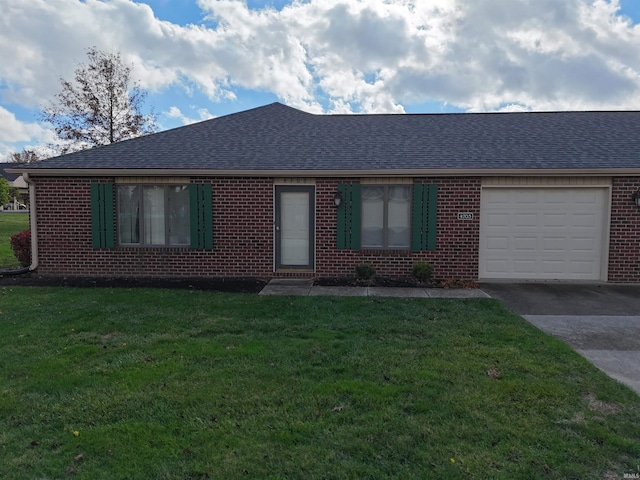 single story home featuring a garage and a front lawn