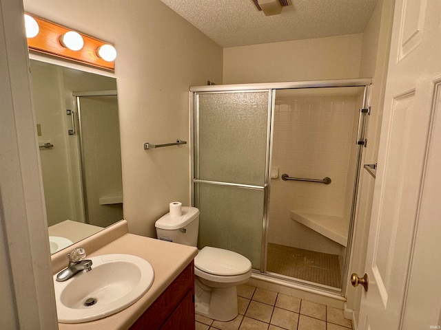 bathroom featuring tile patterned floors, an enclosed shower, vanity, a textured ceiling, and toilet