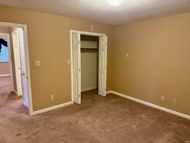 unfurnished bedroom with carpet flooring, a closet, and a textured ceiling