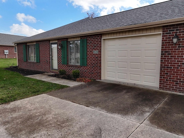 ranch-style house featuring a garage and a front lawn