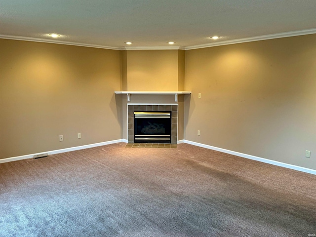 unfurnished living room featuring carpet flooring, crown molding, and a tile fireplace