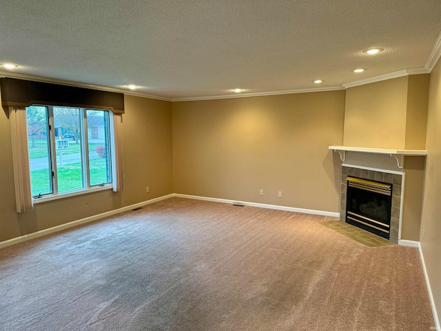 unfurnished living room with light carpet, a textured ceiling, crown molding, and a tiled fireplace