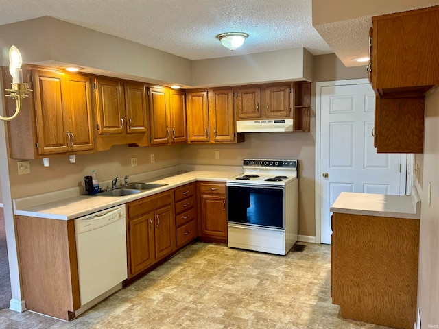 kitchen featuring a textured ceiling, white appliances, and sink