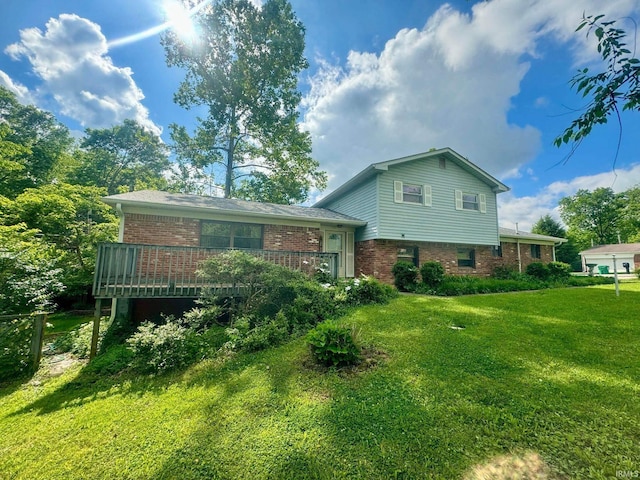 back of property featuring a wooden deck and a yard