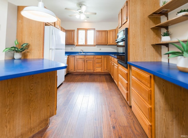 kitchen featuring ceiling fan, sink, dark wood-type flooring, and white refrigerator