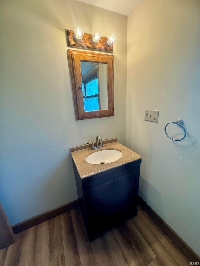 bathroom with hardwood / wood-style flooring and vanity