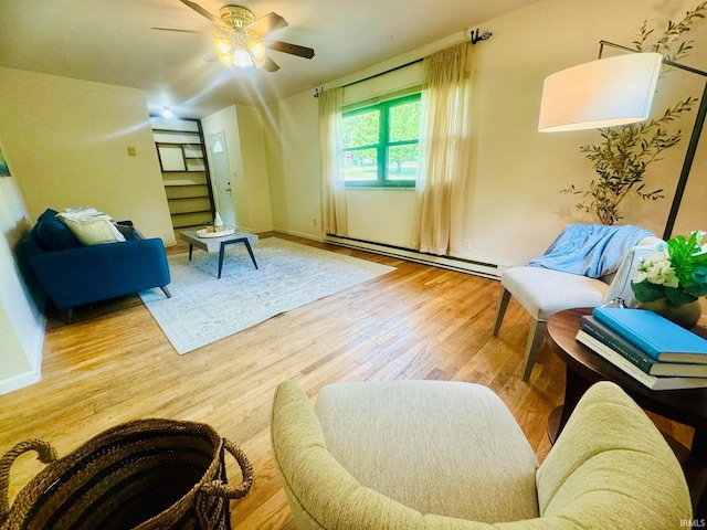 living area with wood-type flooring, ceiling fan, and a baseboard heating unit