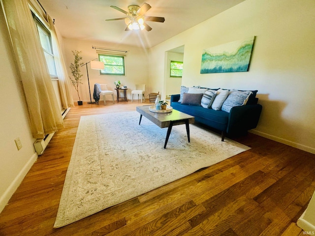 living room featuring ceiling fan and hardwood / wood-style flooring