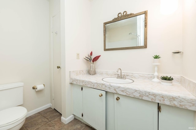 bathroom featuring toilet, vanity, and tile patterned floors