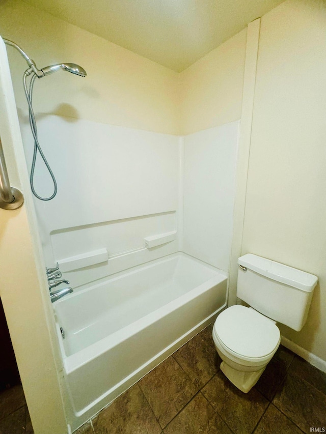 bathroom featuring tile patterned flooring, bathtub / shower combination, and toilet