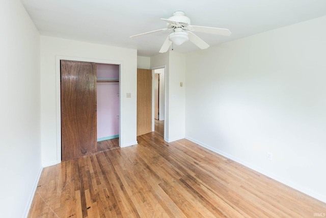 unfurnished bedroom with hardwood / wood-style flooring, a closet, and ceiling fan